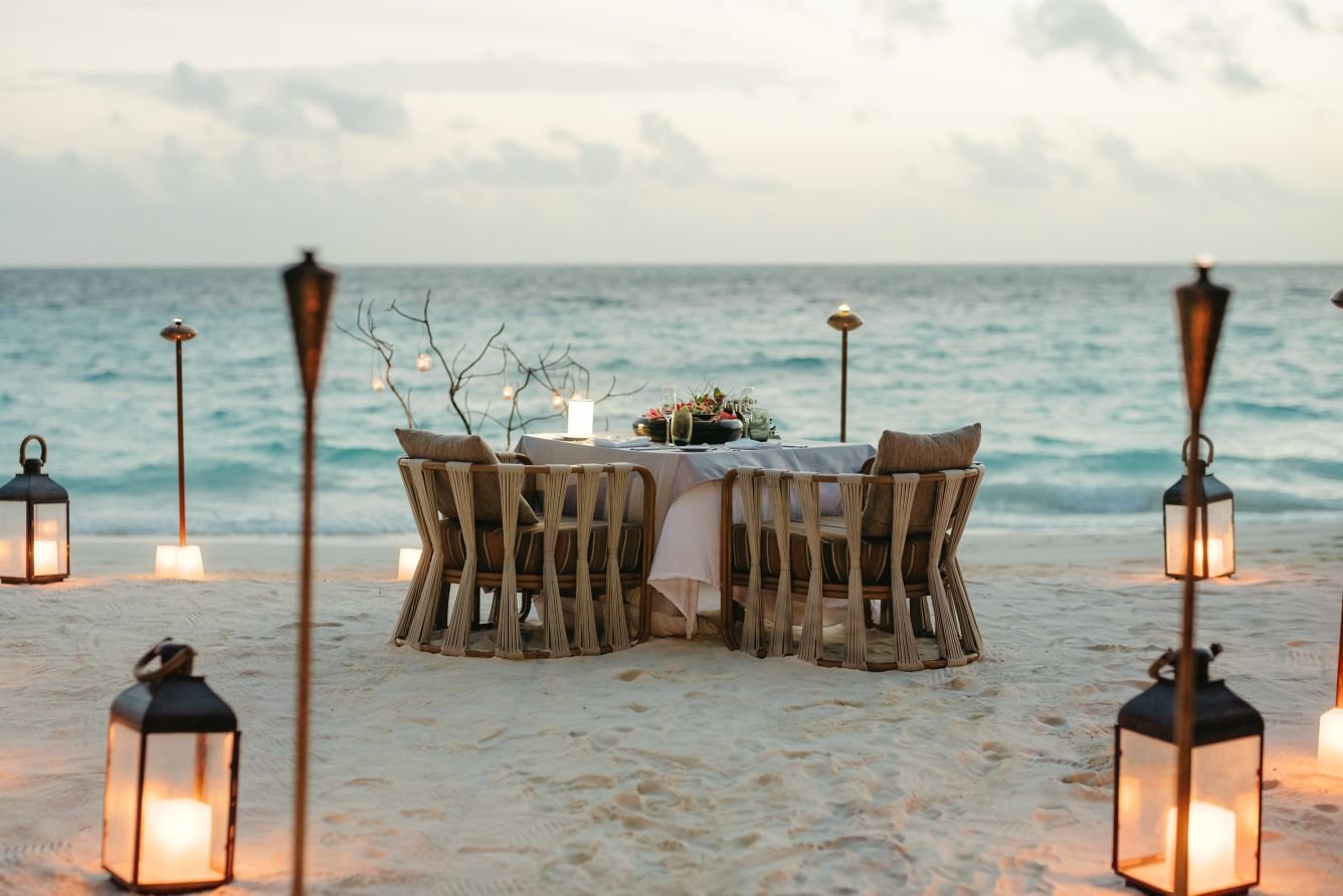 Couple enjoying sunset on Maldives beach